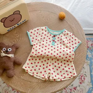 Detail of baby cotton gauze floral set showing soft textured fabric and checkered piping