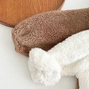 Detail of thick fleece texture in camel and ivory white for baby winter romper