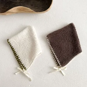Detail of warm fleece baby earflaps with crochet trim and adjustable drawstrings