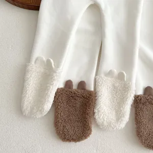 Close-up of white baby leggings featuring 3D plush bear ears on the soft ribbed cuffs