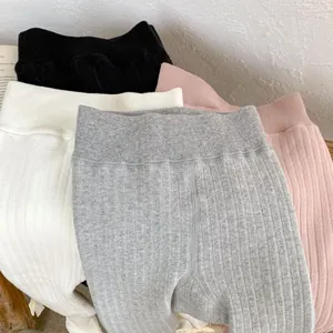 Detailed view of ribbed cotton baby leggings in black, white, grey, and pink colors