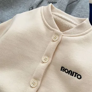 Detail of warm fleece lining and embroidered BONITO lettering on beige kids cardigan