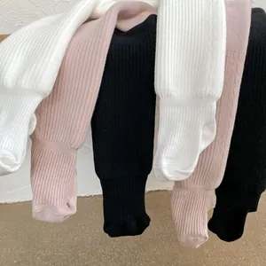 Detail view of ribbed knit baby leggings in white pink and black cotton fabric