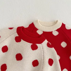 Detail of round neck knit sweaters with polka dot patterns and ribbed necklines for babies