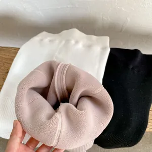 Detail showing thick fleece lining on thermal winter leggings in black, white, and nude