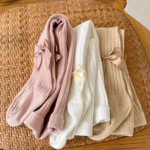 Detailed knit texture and satin bow accents on toddler cotton leggings in three colors
