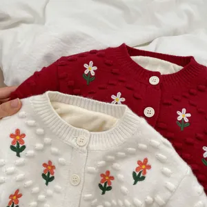 Detalle de cárdigan de punto para niña con bordado de flores y forro polar cálido