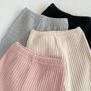 Detail of ribbed knit baby flare pants in pink, cream, grey and black colors