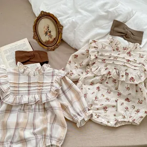 Detail of floral and plaid baby bodysuits with ruffle collars and snap closures