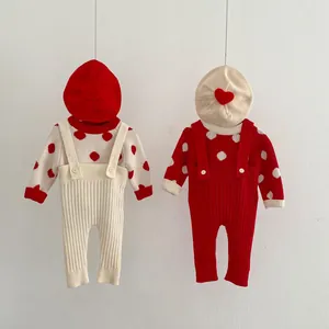 Detail of baby knitted set featuring polka dot sweaters and ribbed suspender trousers