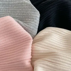 Vertical ribbed knit texture of baby bell-bottom leggings in four minimalist colors