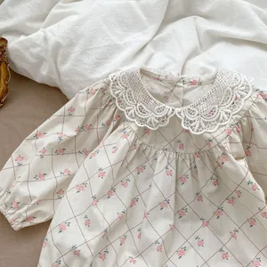 Detail of baby floral bodysuit with lace Peter Pan collar and quilted rose patterns