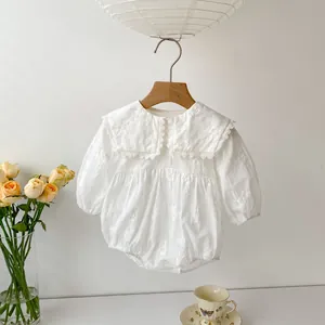 Detailed embroidery and lace collar on white long-sleeve cotton baby bodysuit
