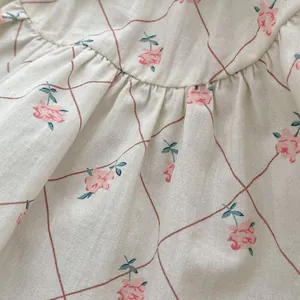 Detailed macro view of floral cotton fabric with pink blossoms and pleated stitching