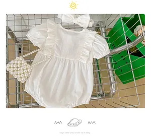 White cotton baby romper set with ruffles, matching bow headband and mini pearl bag