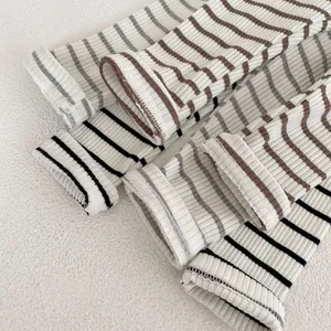 Close-up of ribbed cotton infant leggings showing striped knit texture and hem detail