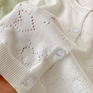 Baby girl white knit cardigan with heart hollow patterns and wave edge details