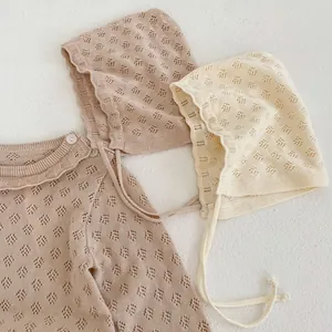 Detail of baby knit romper and matching hat with diamond pointelle hollow pattern