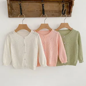 Detailed heart-shaped hollow knit pattern on white, pink and green baby cardigans
