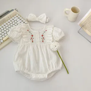 White cotton baby bodysuit with floral embroidery, ruffles and matching headband
