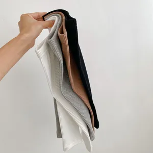Detailed texture of baby ribbed leggings in multiple colors with elastic waistband