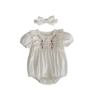 White cotton baby girl romper with red floral embroidery and matching bow headband