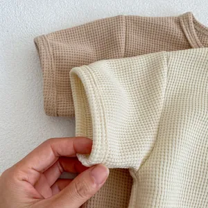 Detail of waffle knit fabric texture and fine stitching on baby short sleeve tops