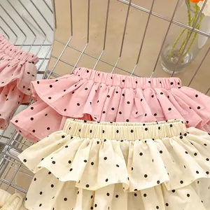 Detailed view of polka dot ruffle baby shorts in pink and beige cotton fabric