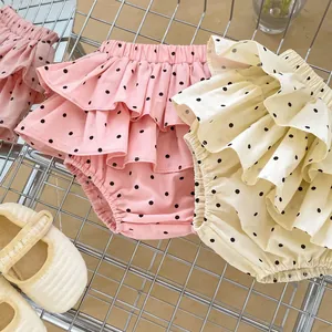 Detail of infant ruffle bloomers with polka dot patterns and elastic waist in soft summer cotton
