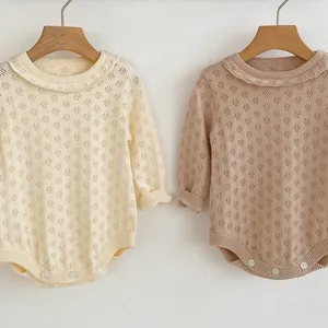 Detail of baby long sleeve knit romper featuring hollow diamond patterns and ruffled collar