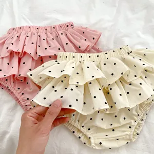 Infant cotton ruffle diaper cover shorts with black polka dots in pink and beige