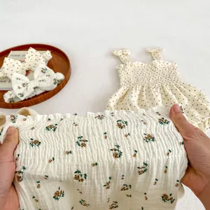 Floral baby girl romper with bow headband featuring high-stretch smocked cotton fabric