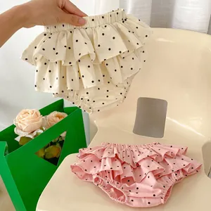Detail of sweet toddler girls polka dot bloomer shorts with layered ruffle lace trim