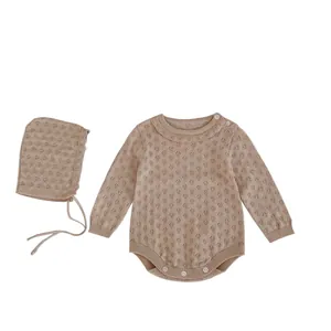 Knitted long-sleeve baby romper with matching hat featuring hollow jacquard pattern