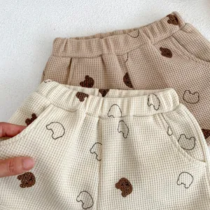 Detailed view of waffle knit cotton toddler shorts with bear prints and elastic waist