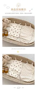 Detail of infant sleeveless cotton rompers with bear and floral prints and crotch snaps
