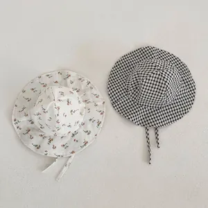 Détails de chapeaux de soleil pour bébé avec motifs à fleurs et carreaux et lanières