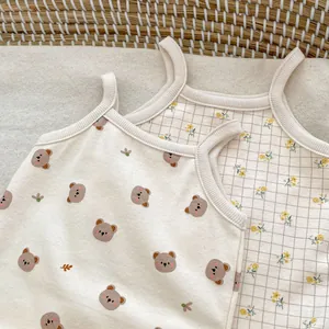 Detail of infant sleeveless cotton bodysuits with bear print and floral checkered patterns