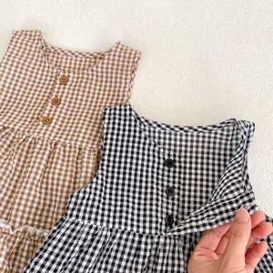 Detailed view of breathable cotton checkered baby tops with wood-style buttons