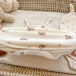 Sleeveless baby bodysuit with cute bear print on soft off-white cotton fabric