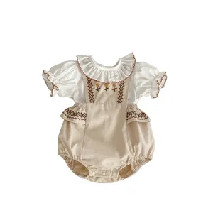 Baby girl floral embroidery romper with ruffle trim and snap bottom in white and apricot