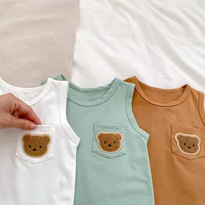 Detailed view of baby cotton tank tops with cute 3D bear embroidery and pocket details