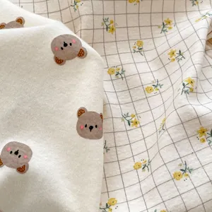 Sleeveless baby romper with cute bear prints and yellow floral patterns on soft knit fabric