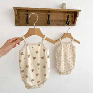 Detail of baby sleeveless rompers with bear and floral prints and bottom snap buttons