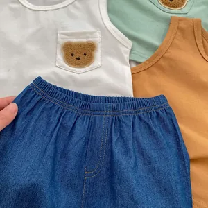 Detail of baby summer vest and denim shorts showing cotton fabric and bear pocket