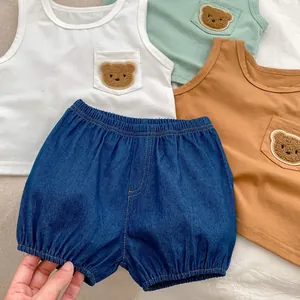 Detail of baby summer vest set with cute 3D teddy bear patch and denim shorts