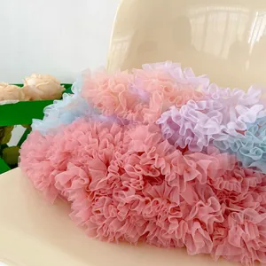 Close-up of layered pleated tulle ruffles in pastel pink blue and purple colors