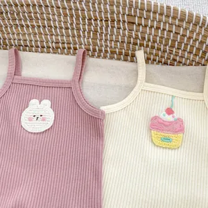 Detail of ribbed cotton camisole tops featuring cute bunny and cupcake embroidery