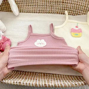 Detail of soft ribbed cotton baby camisoles with cute bunny and cupcake embroidery