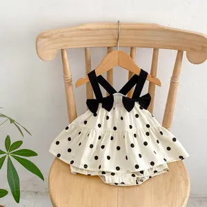 Baby girl summer polka dot bodysuit with black bow straps and layered skirt design